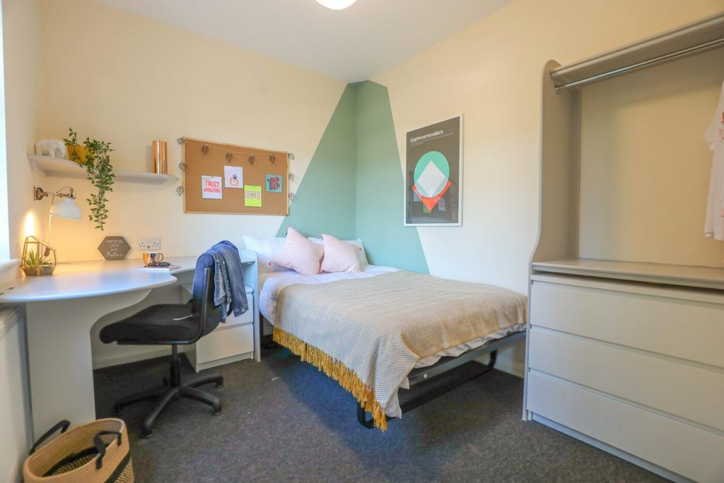Bright and neatly decorated double bedroom with...