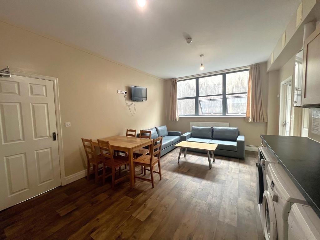 Bright open-plan living area with large front w...