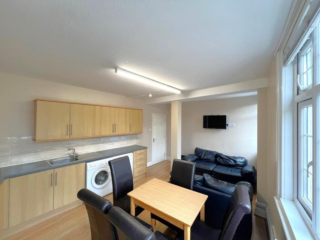 A bright and well-maintained living room featur...
