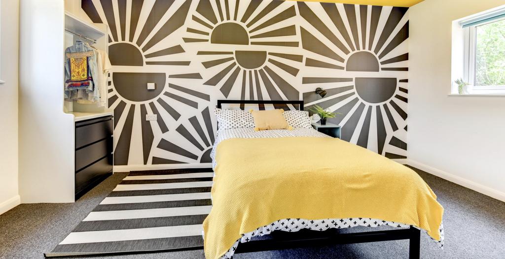 This vibrant double bedroom features a stylish ...