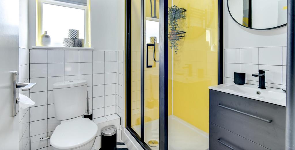 A stylish and modern bathroom featuring a sleek...