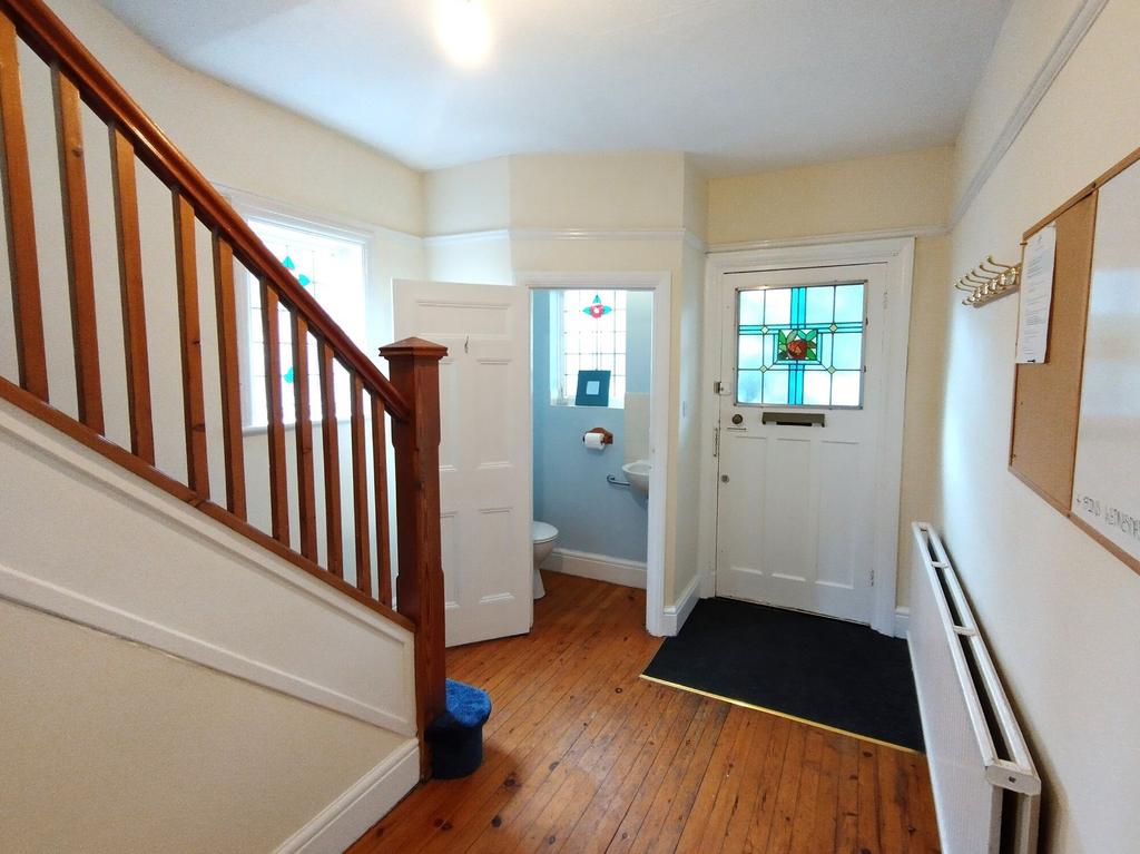 Bright, welcoming hallway with polished wooden ...