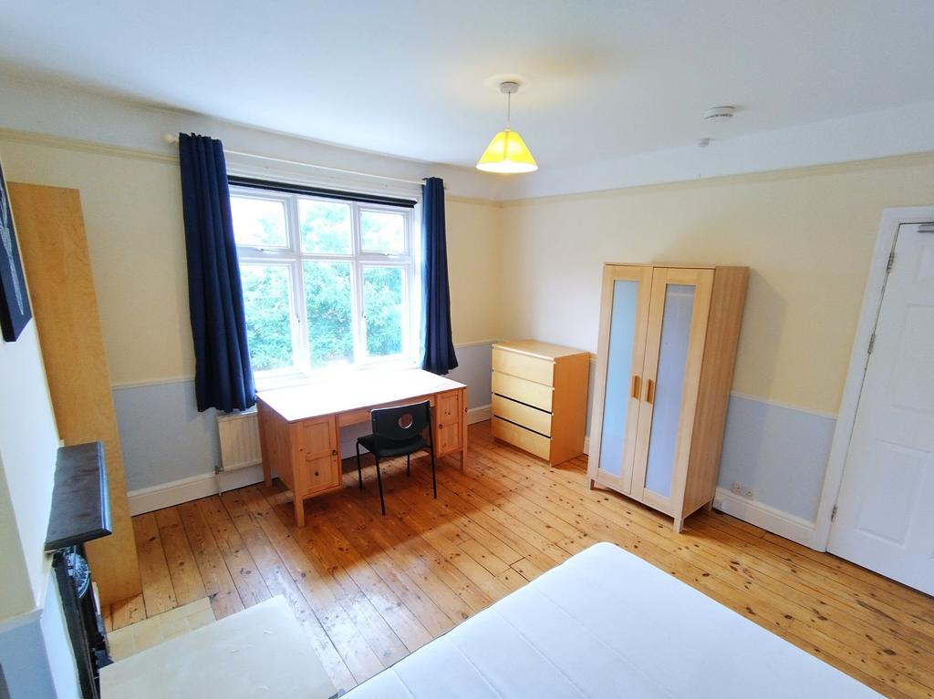 Bright, well-presented bedroom with a large win...