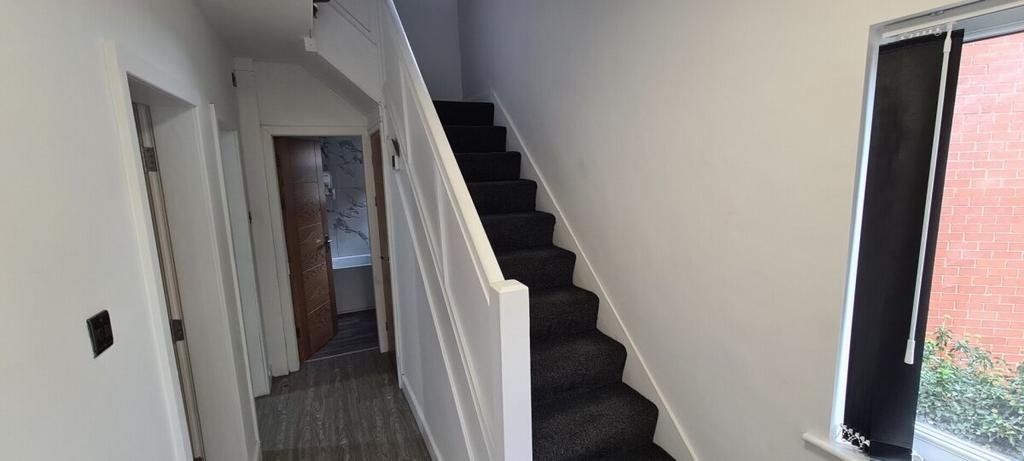 A tidy and well-maintained hallway featuring a ...