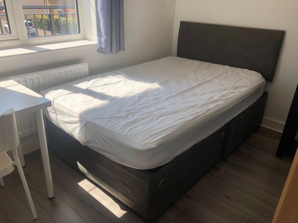 Bright, neatly presented bedroom with a comfy d...