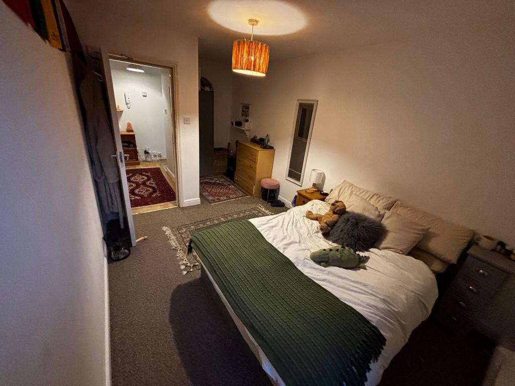 Cozy double bedroom with a comfortable made bed...