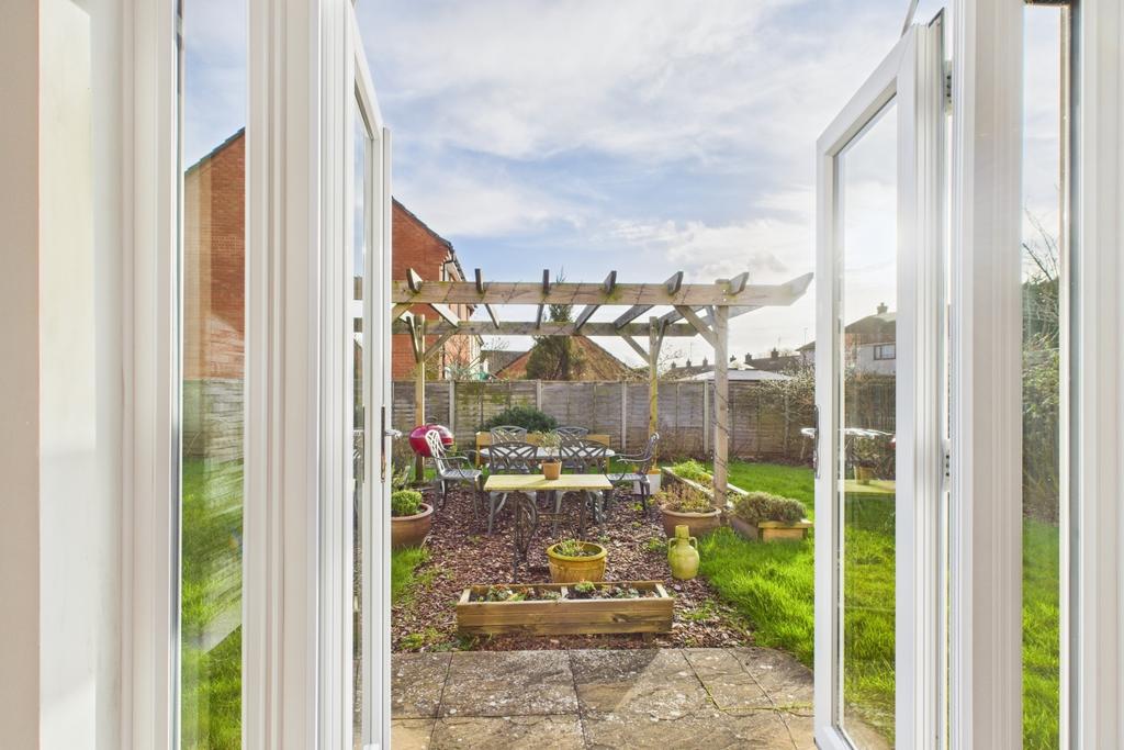 Patio doors opening to the garden and seating area