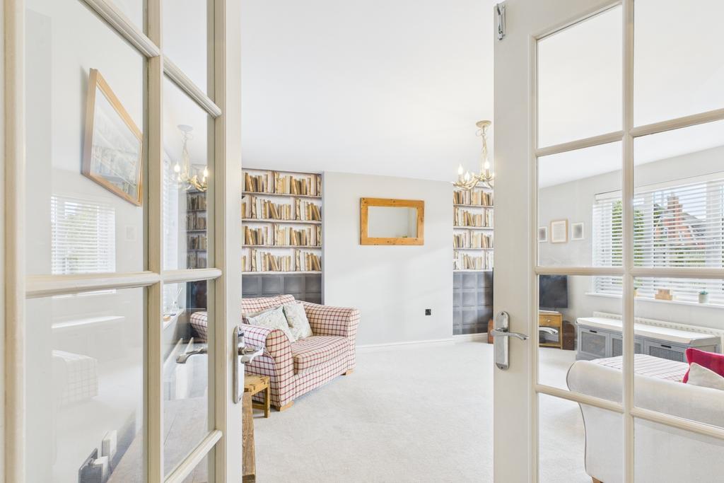Double doors open into a spacious, light-filled li