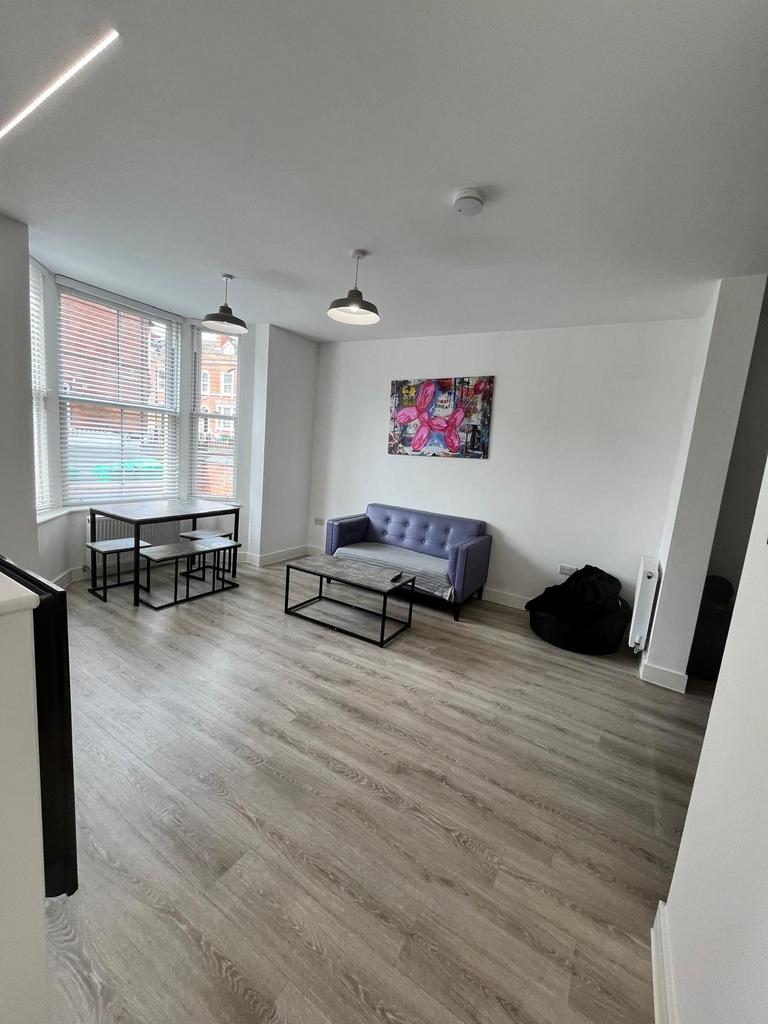 Bright, modern living room with large bay windo...