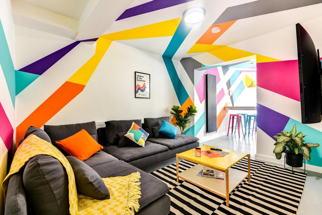 This vibrant living room features colorful wall...
