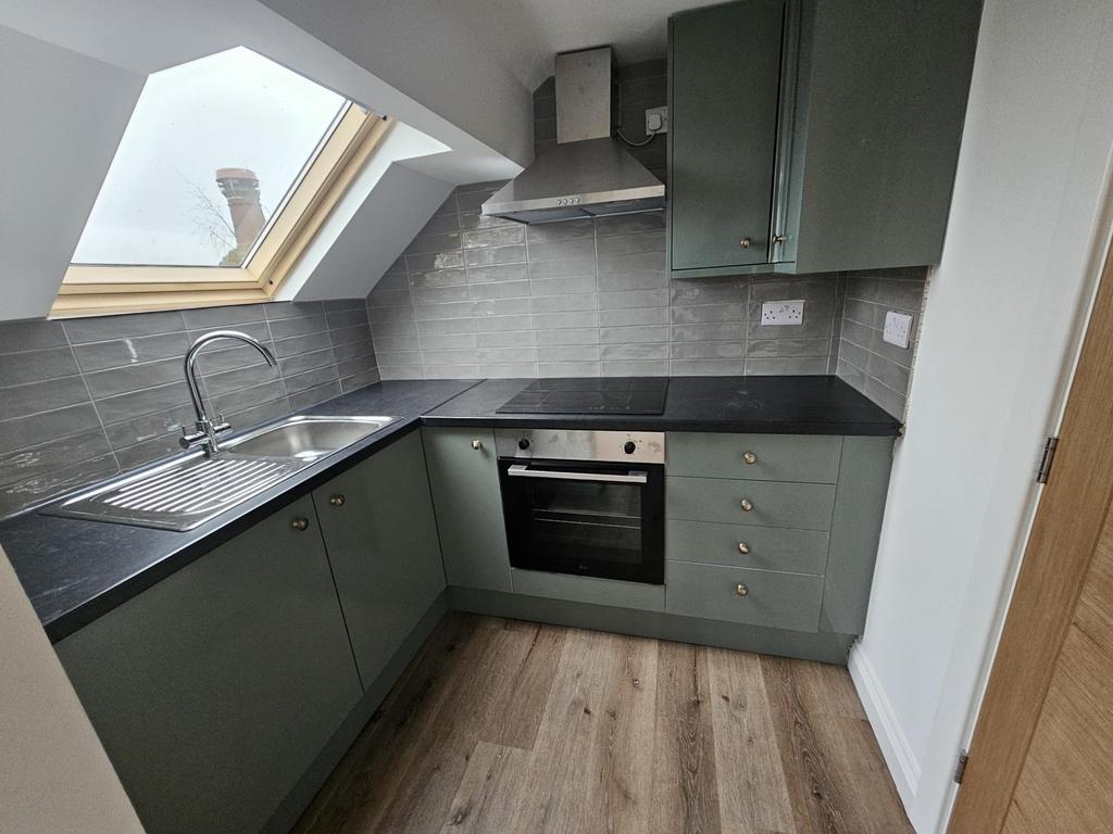 Modern compact kitchen with L-shaped dark count...
