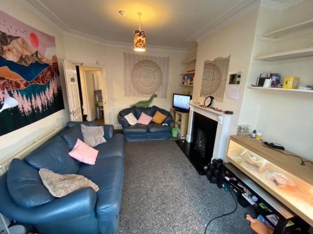 Bright, comfortable living room with two blue s...