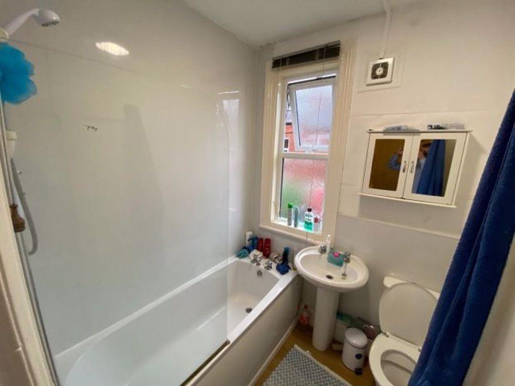 Bright, well-kept bathroom with a full bath and...
