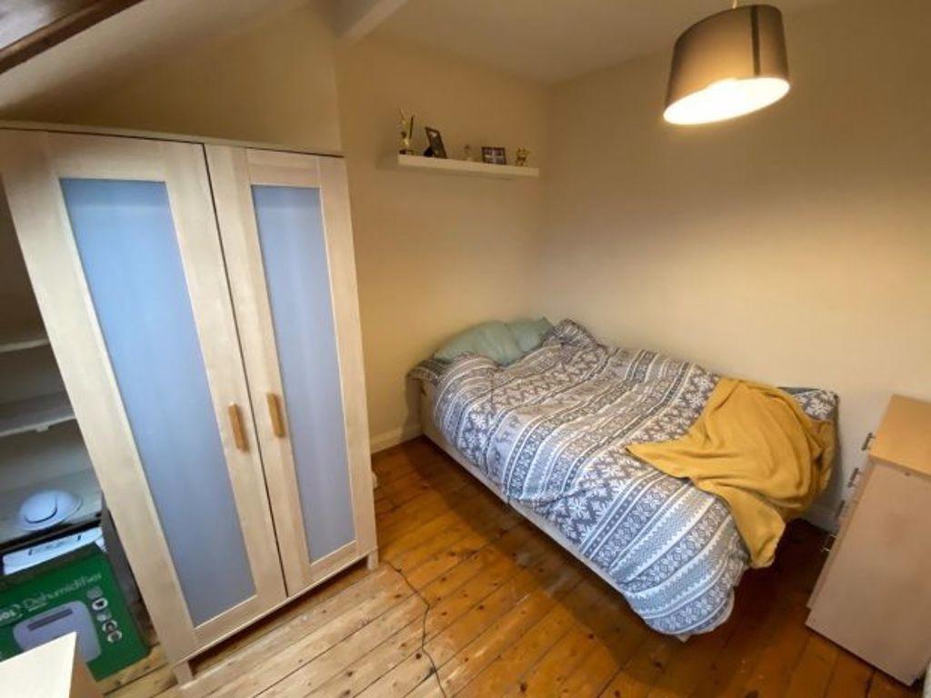 Neat single bedroom with wooden floors, cosy si...