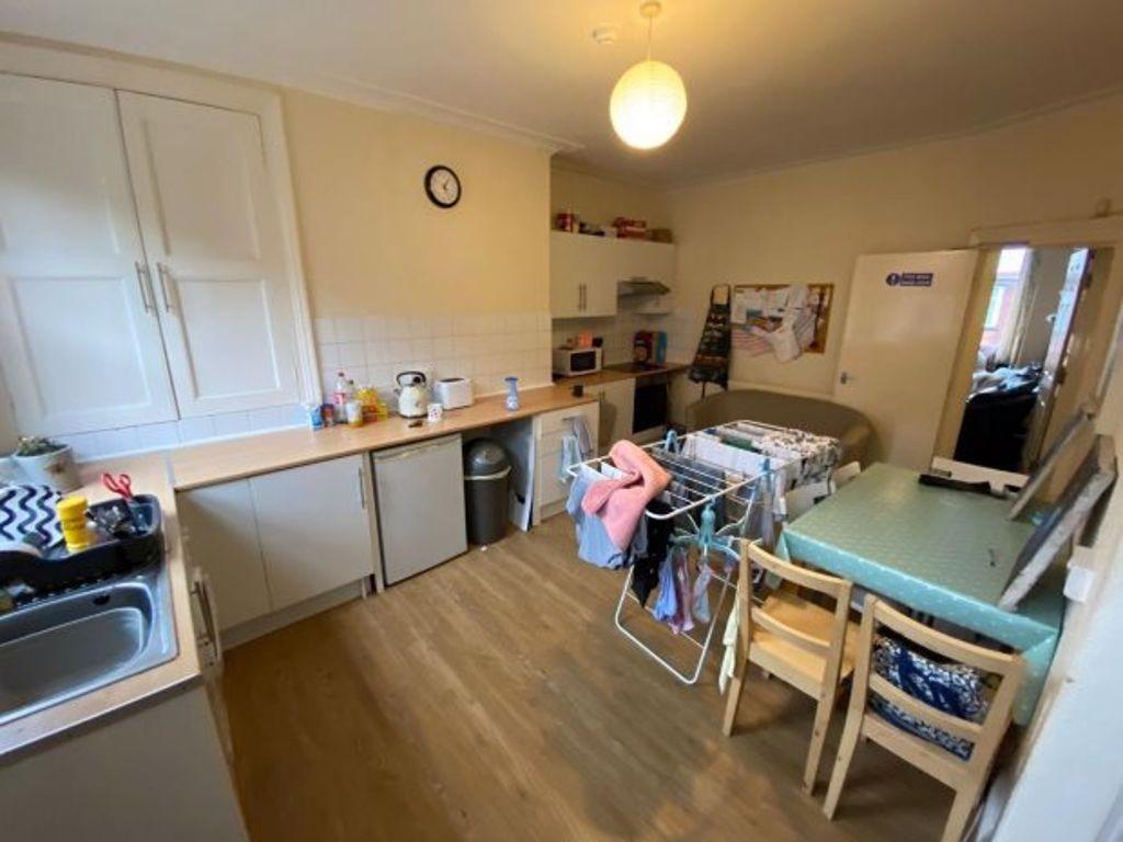Bright, functional shared kitchen with long wor...