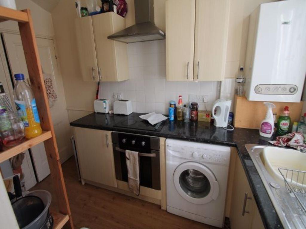 Compact fitted kitchen with matching wall and b...