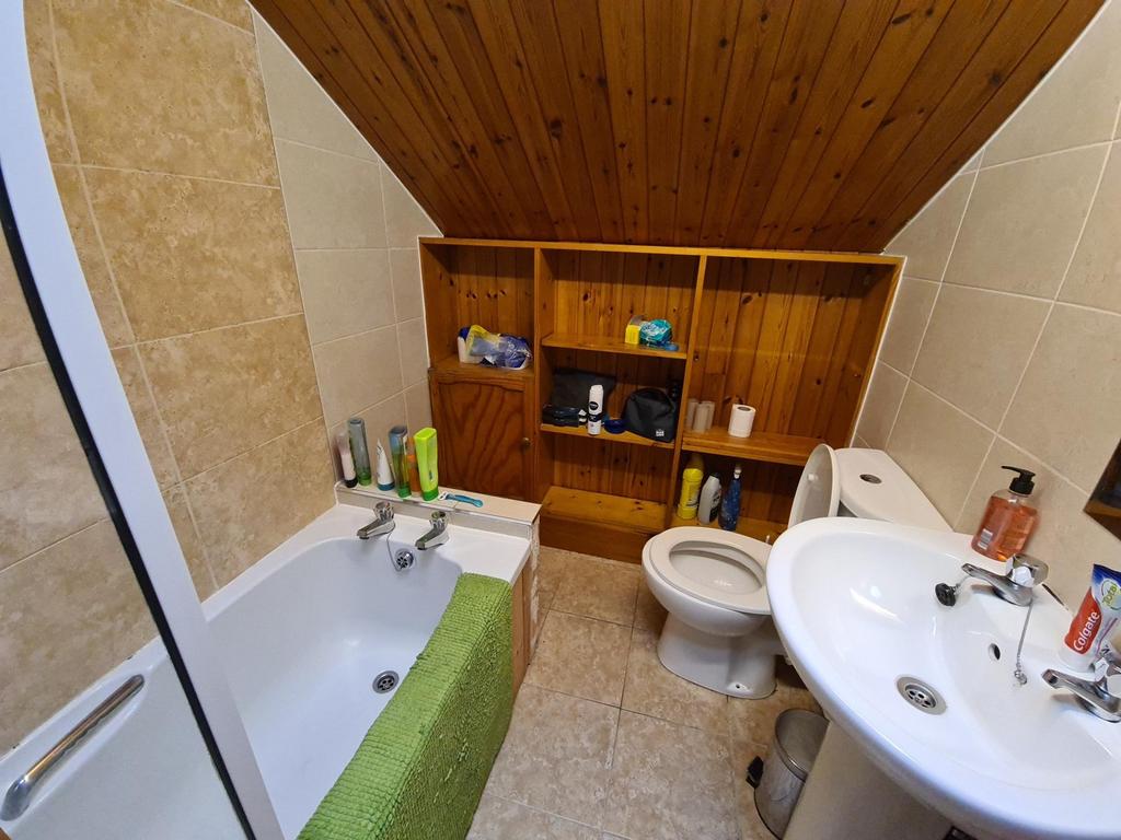 Well-equipped bathroom with a bath and overhead...