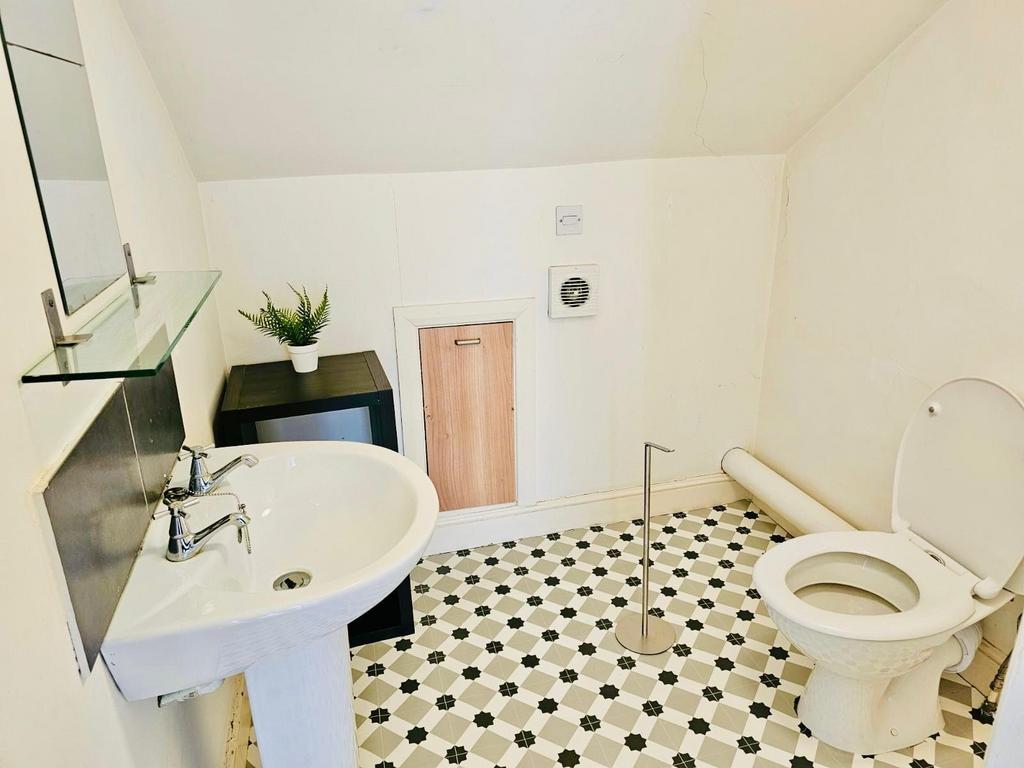 Bright, clean bathroom with classic black-and-w...