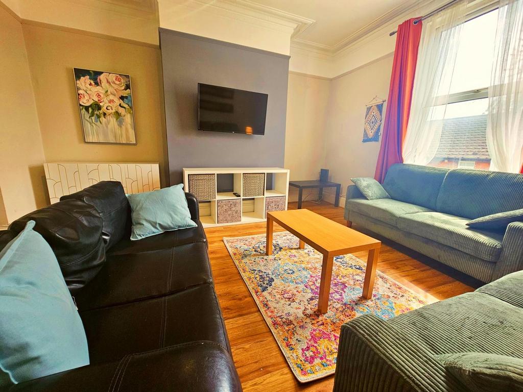 Bright, well-kept living room with two sofas, a...