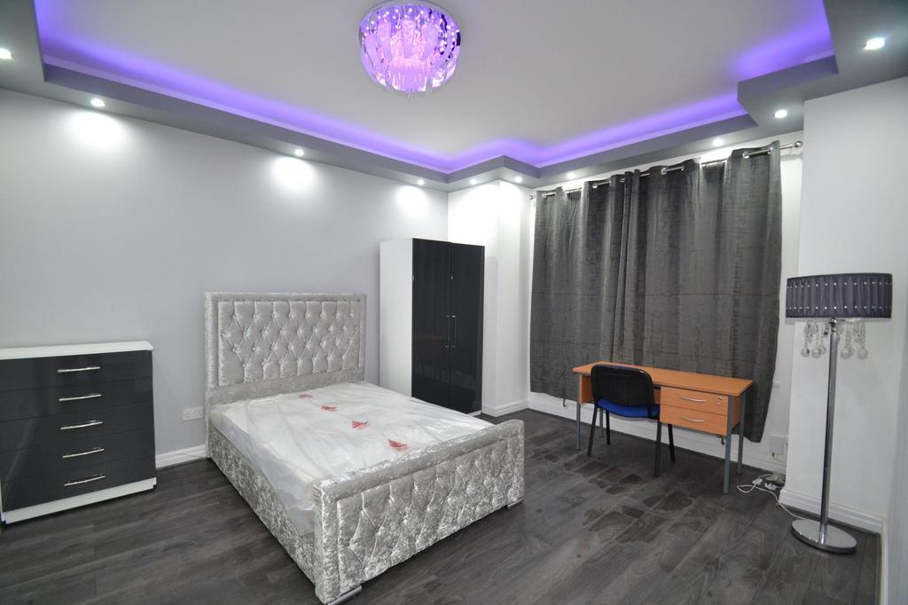 A modern, well-lit bedroom featuring a plush tu...