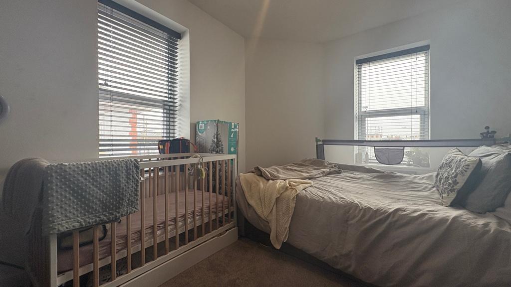 Bright, neutral double bedroom with two windows...