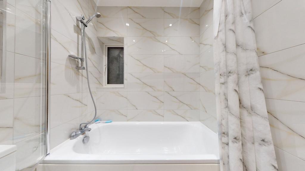 Bright, modern bathroom featuring a full bath w...