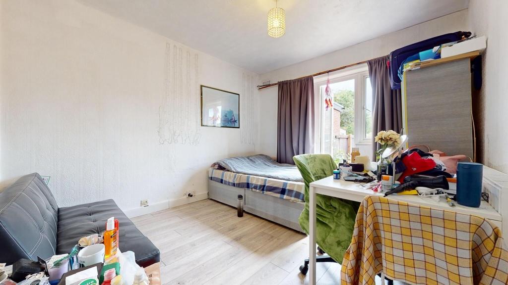 Bright single bedroom with a large window letti...
