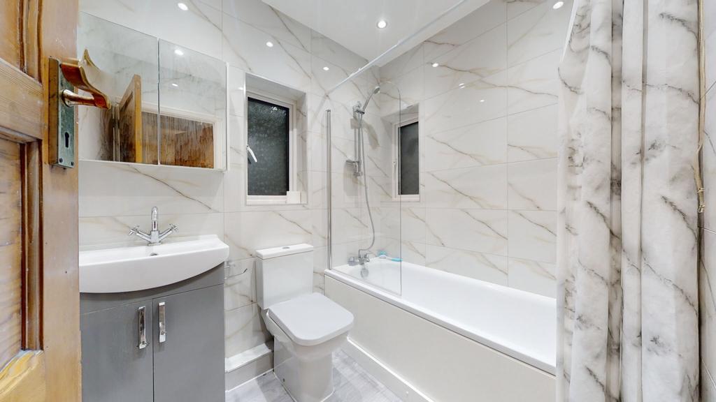 Bright, modern bathroom with a full bath and sh...