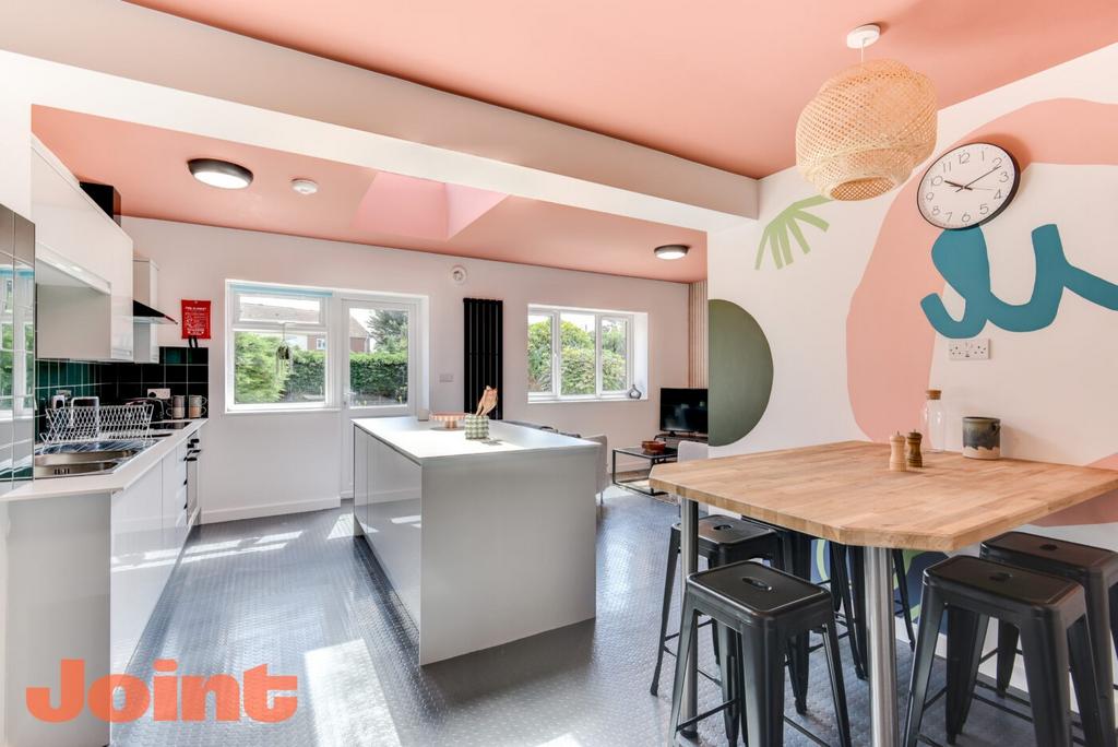 Bright, contemporary open-plan kitchen with a c...