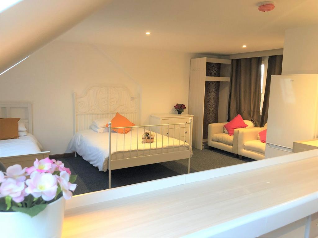 A bright and tidy double bedroom featuring two ...