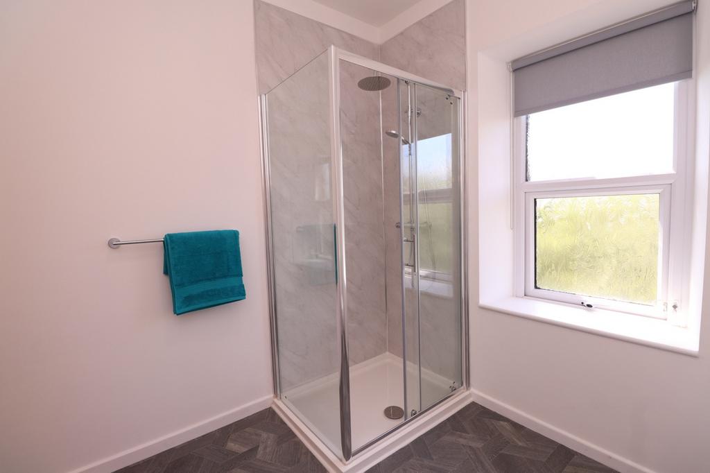 A modern and pristine bathroom featuring a spac...