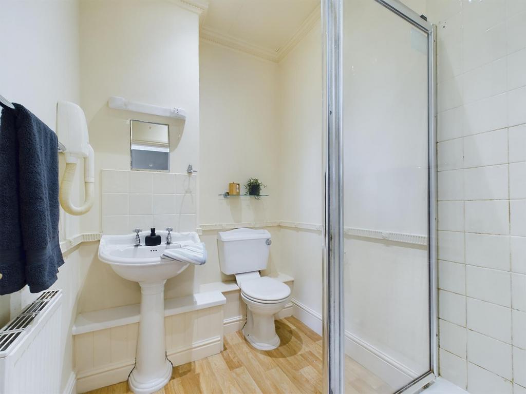 A bright and functional bathroom featuring a sh...