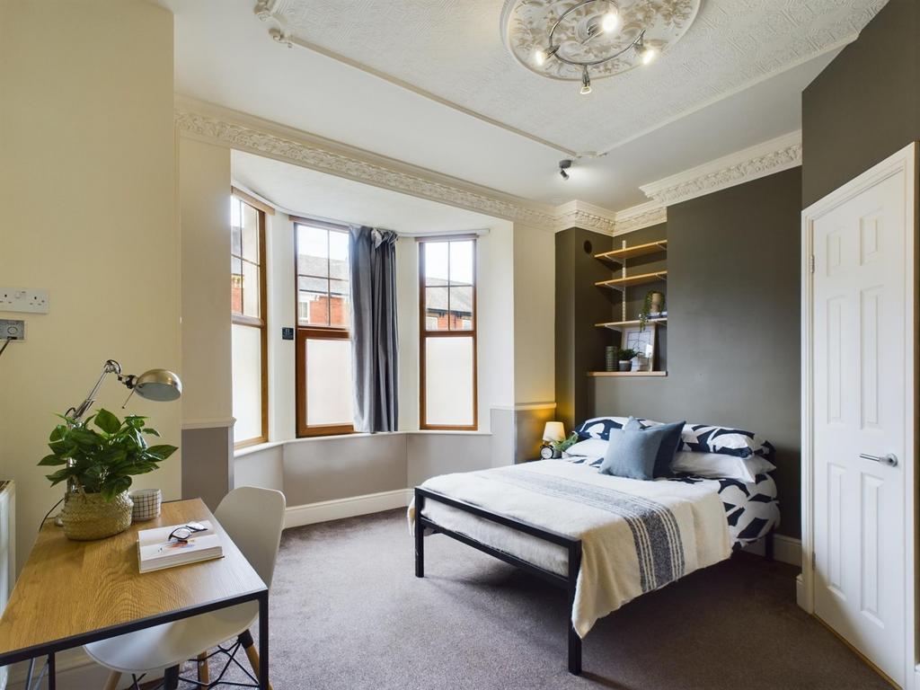 A bright and inviting double bedroom featuring ...