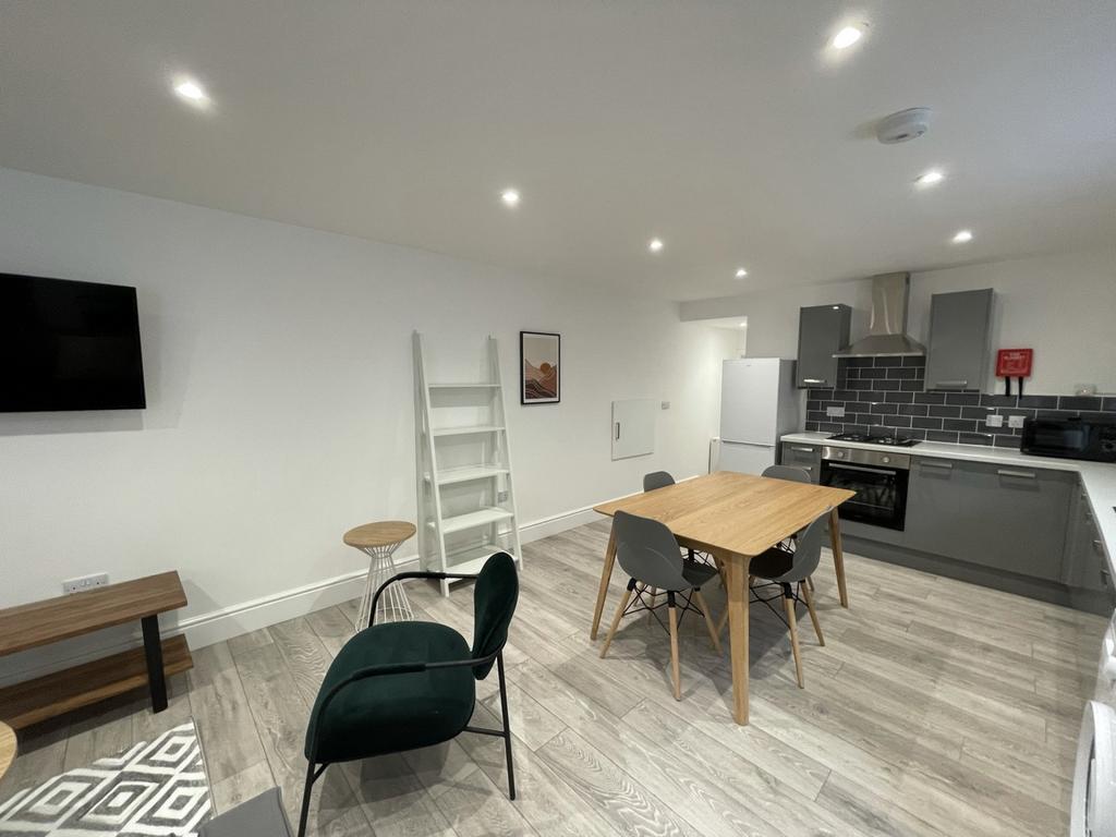A modern and inviting kitchenette with ample sp...