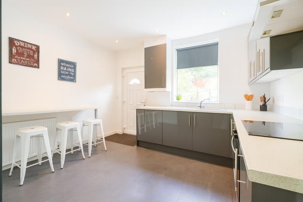 Bright modern kitchen with glossy grey cabinets...