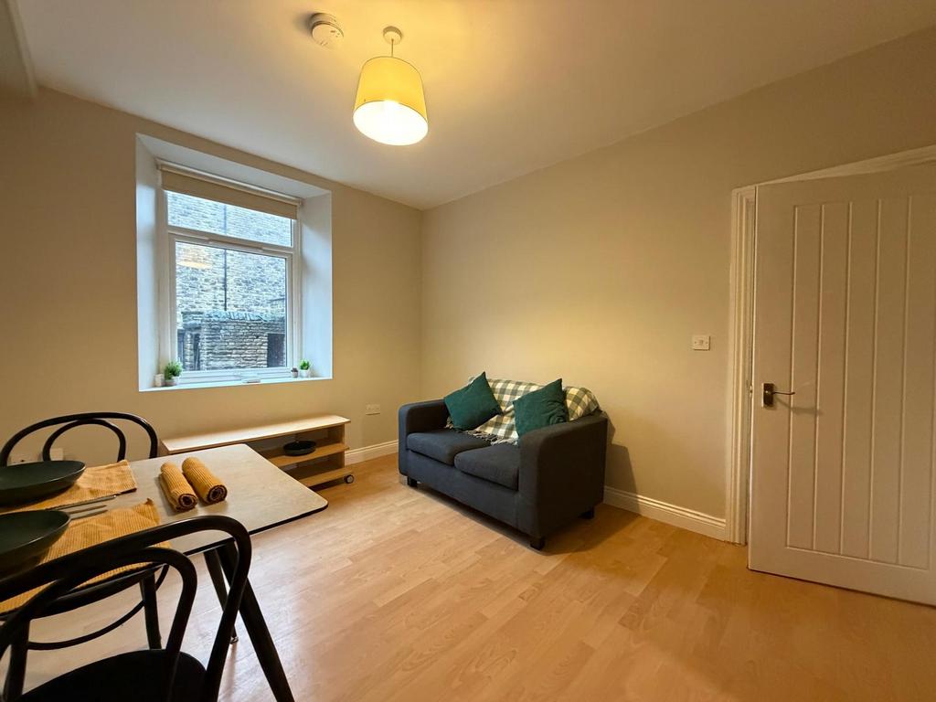 Bright, neatly furnished living area with a com...