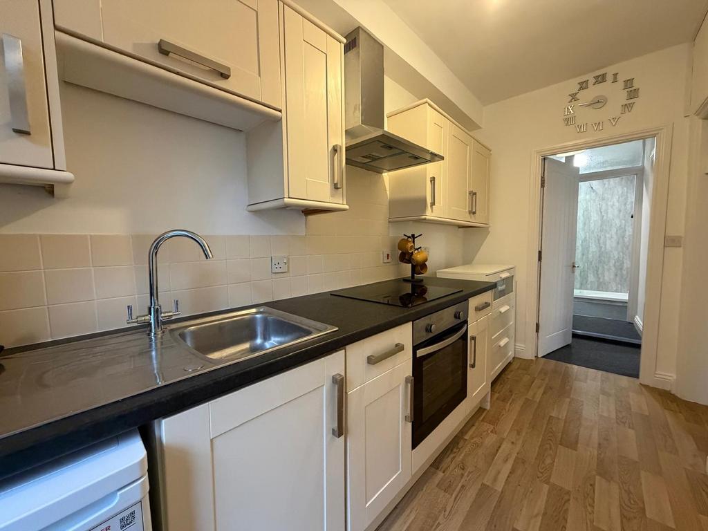 Bright fitted kitchen with a modern oven, ceram...