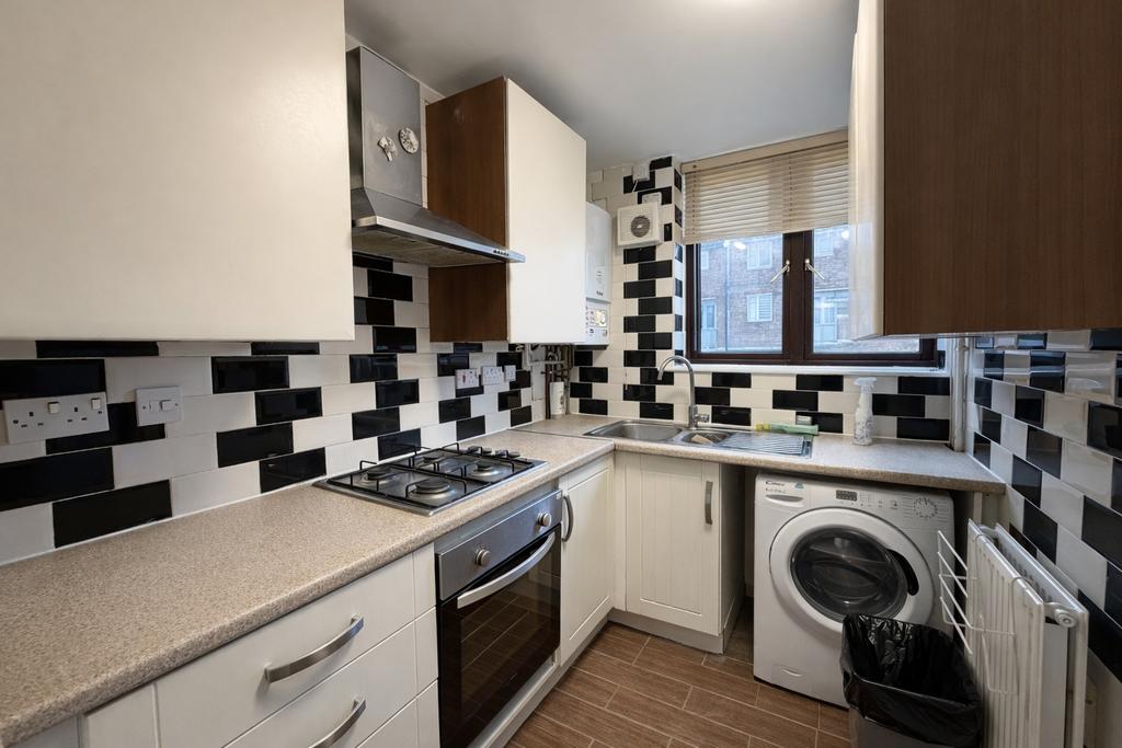 Bright, modern galley kitchen with a gas hob an...