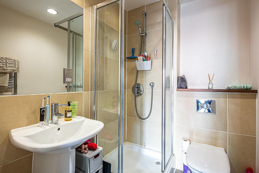 Bright modern bathroom with a glass shower encl...