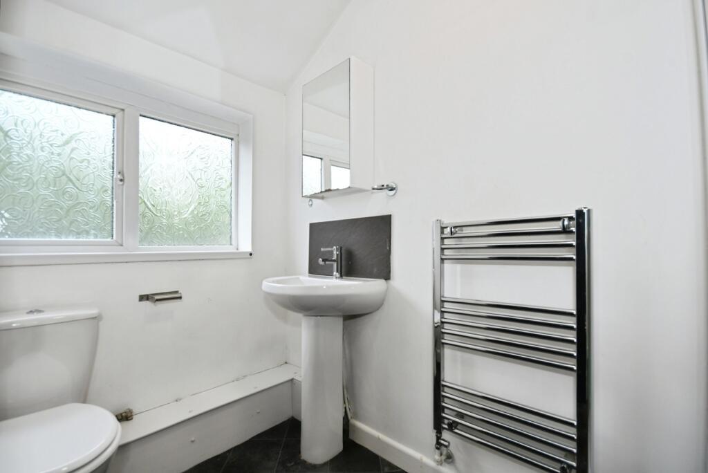 Bright, modern bathroom with frosted window, pe...