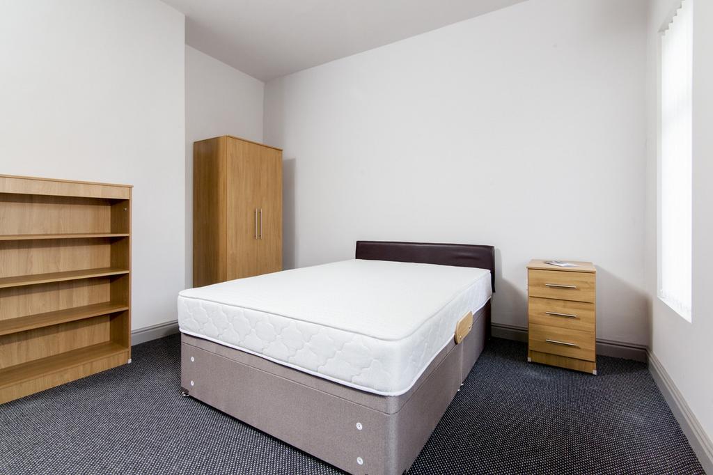 Spacious double bedroom featuring a comfortable...
