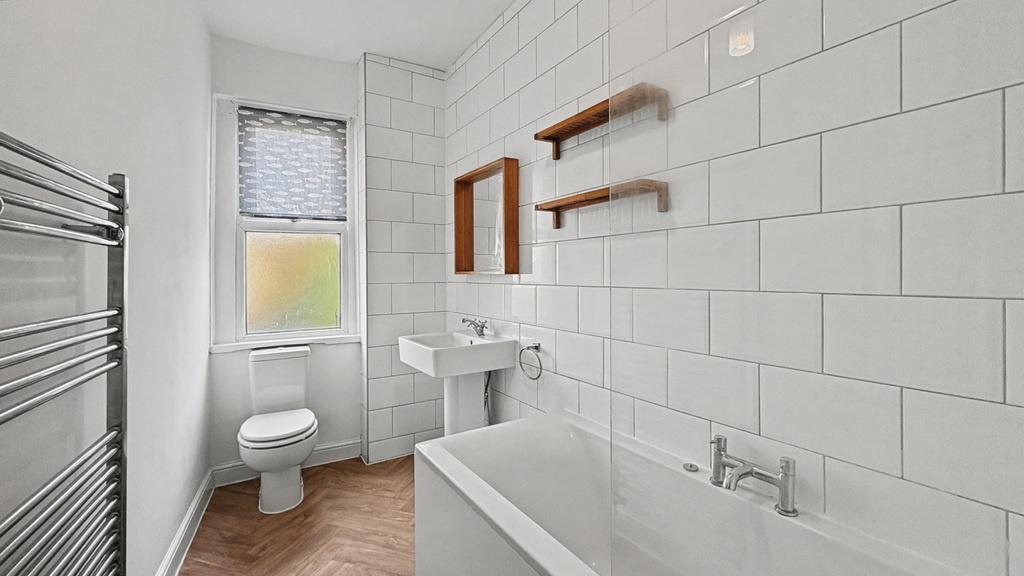 Bright, modern bathroom with white subway tiles...