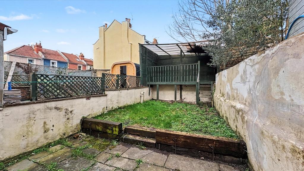 Enclosed rear garden with a paved patio, raised...