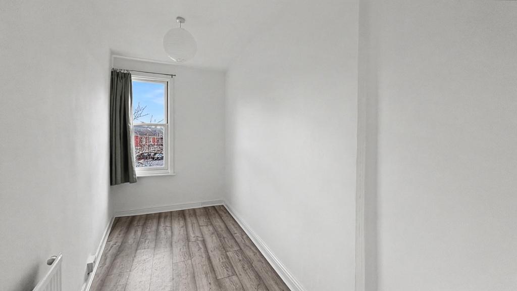 Bright, freshly painted single bedroom with a l...
