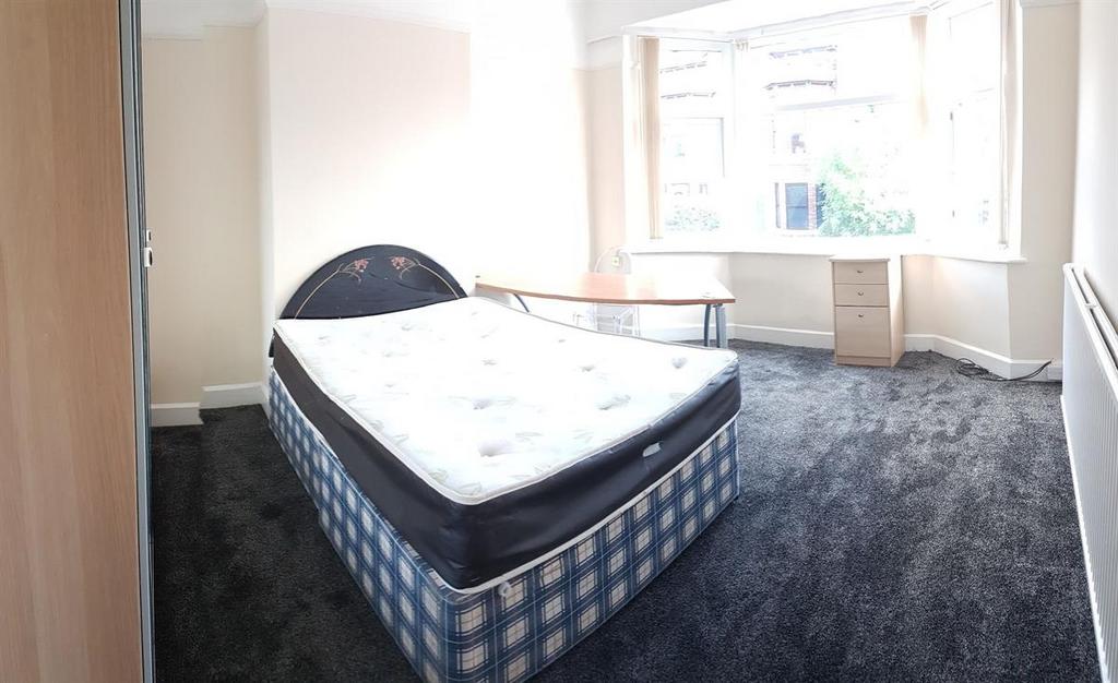 Bright double bedroom with a large front-facing...