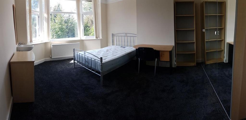Bright bedroom with a large bay window, fitted ...