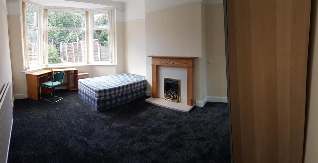 Bright bedroom with a bay window letting in nat...