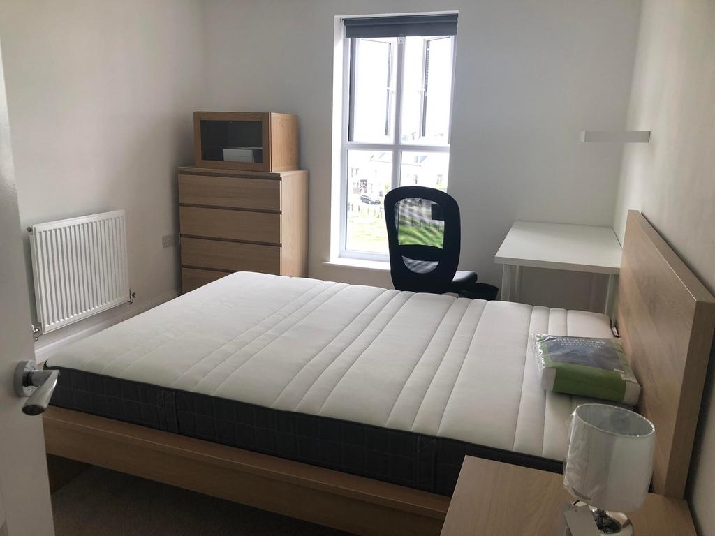 A bright and tidy double bedroom with a comfort...