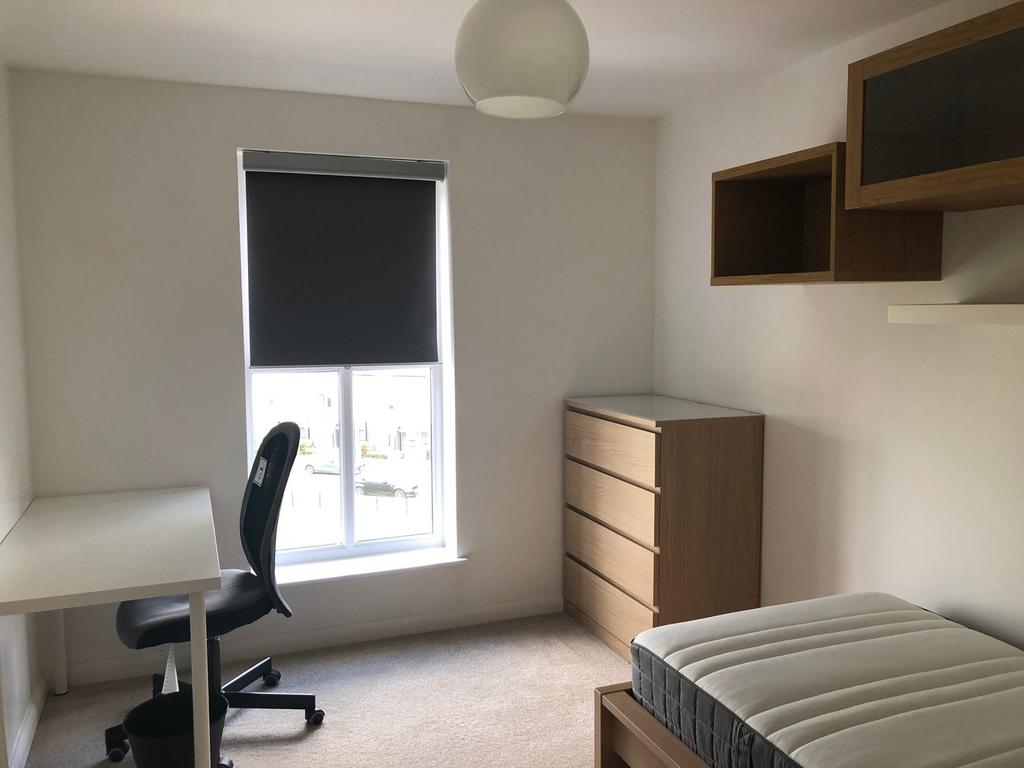 A bright and tidy double bedroom featuring a co...