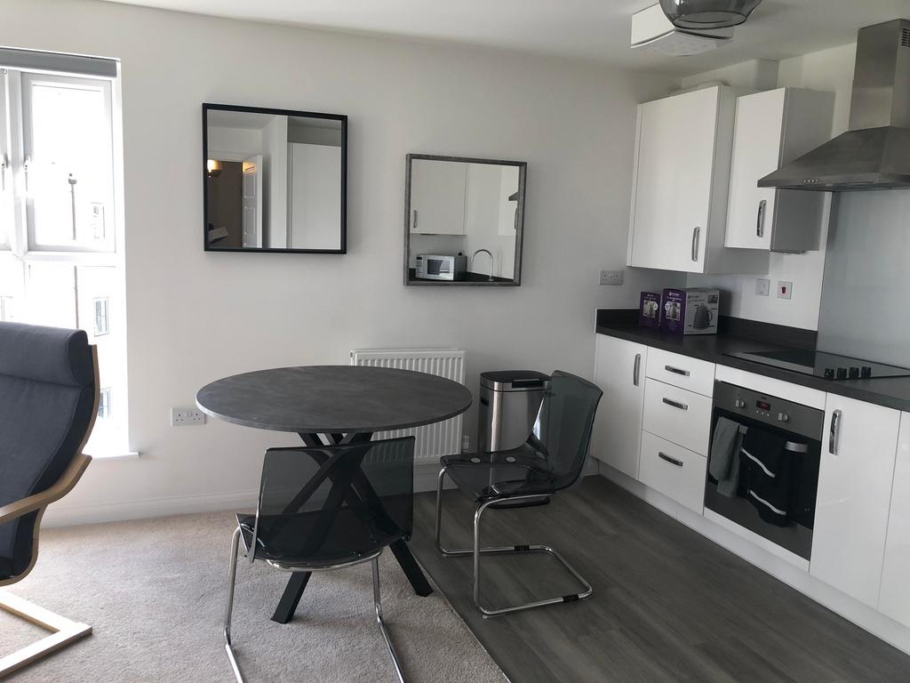A bright and modern kitchen with ample space fo...